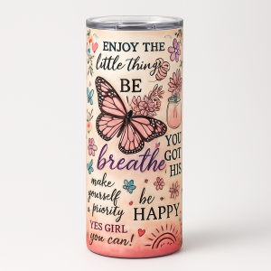 =Peach-pink ombré tumbler with clear lid, decorated with a pink butterfly, flowers, and motivational quotes such as “Enjoy the little things,” “breathe,” and “be happy.”